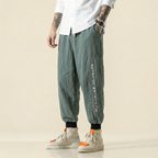 Mingrui Flow Pants in army green with script detail, front view