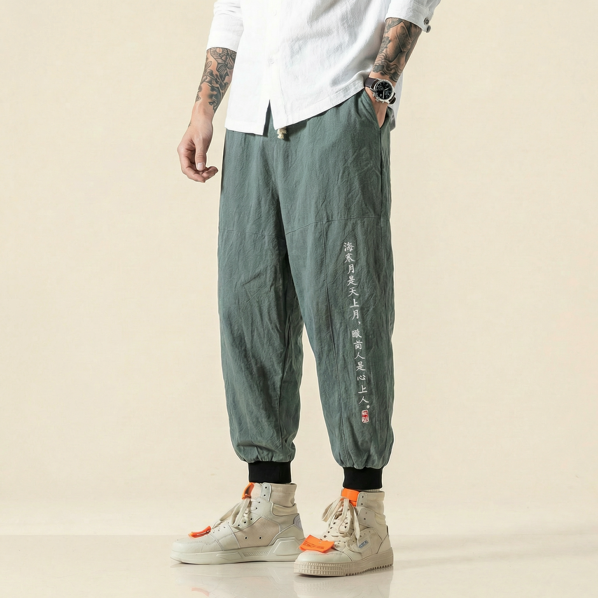 Mingrui Flow Pants in army green with script detail, front view